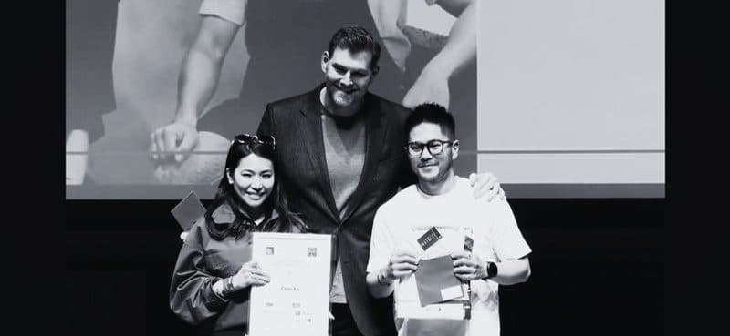 Team members holding an award certificate