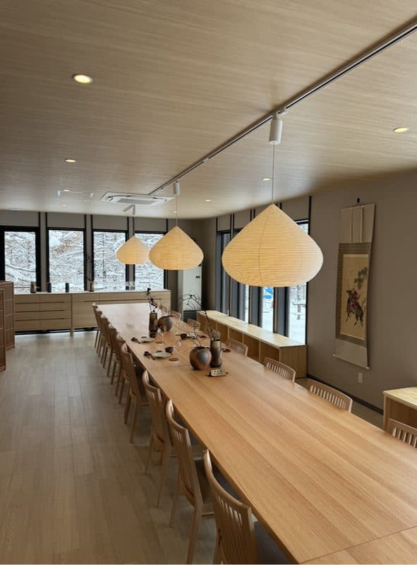 Nani Kore Kani's long communal table under conical paper lanterns